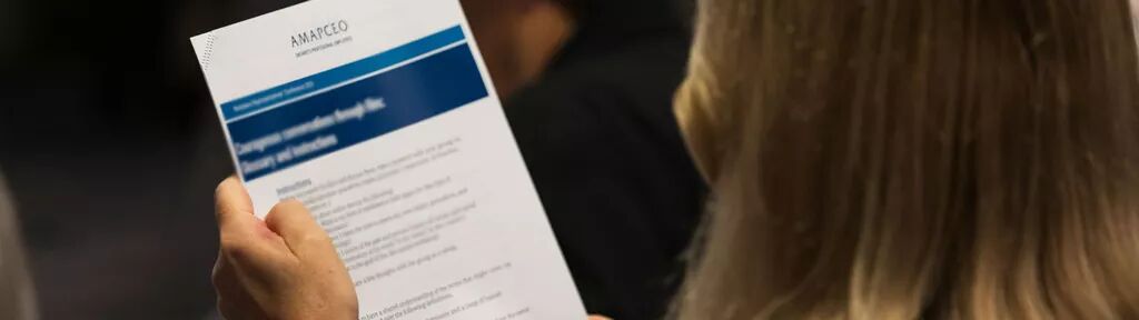 a person holding an AMAPCEO document