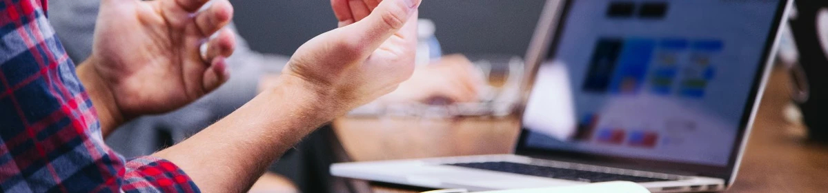 a person at a conference table gesturing