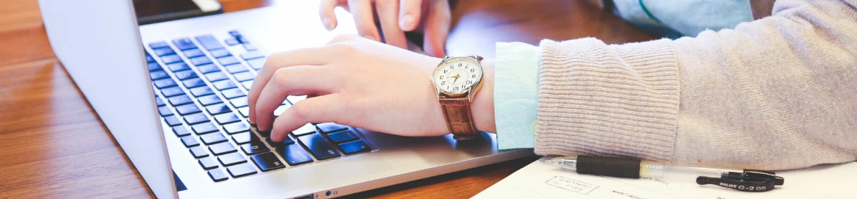 Member typing on a laptop
