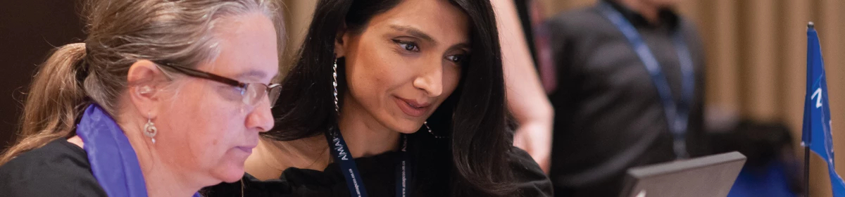 Two AMAPCEO members focussed on a laptop