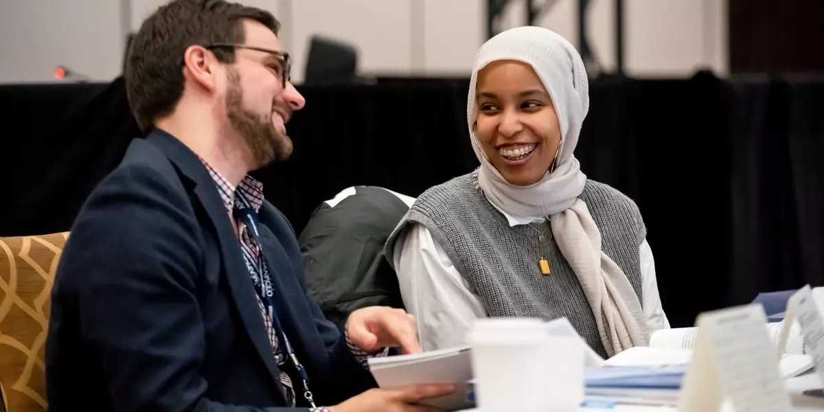 Members smiling and talking at an event