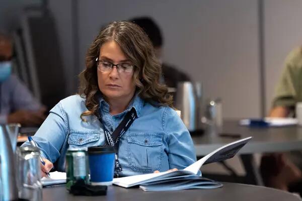 Member writing in a notebook