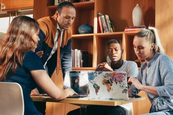 Group of people sitting in an office looking at their laptops