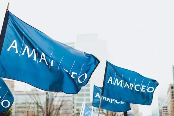Several large AMAPCEO flags waving