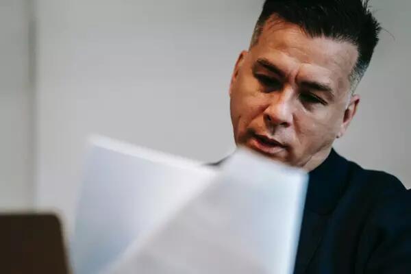 a person looking over a series of documents 