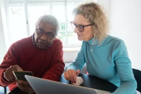 Two people looking at a laptop