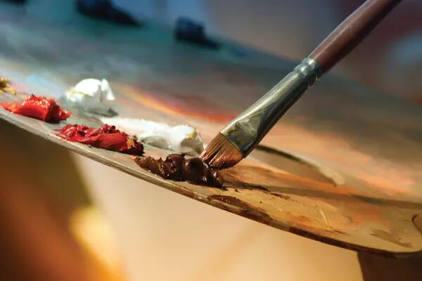 A painter's brush against a palette