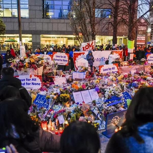 Crowd gathered at Toronto Strong vigil with signs and flowers