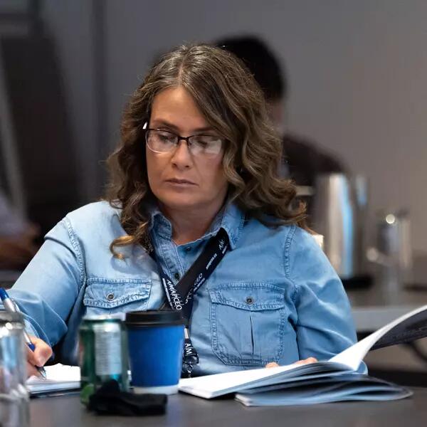 Member writing in a notebook