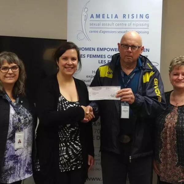 AMAPCEO members handing a cheque to volunteer group Amelia Rising