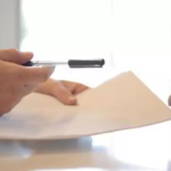 Image of two sets of hands where one set is showing a piece of paper to the other set