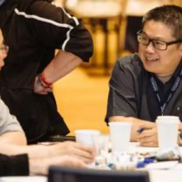 Photograph of Board member Landsay Tom laughing with a member.