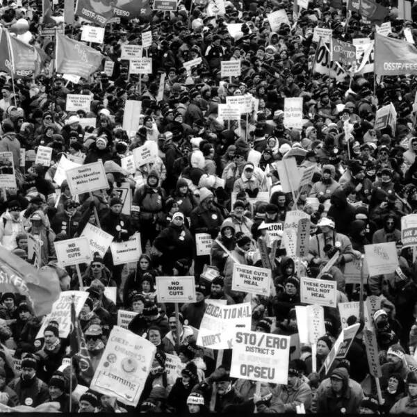 Historical photo of a crowd of protestors, taken from Mayworks' Days of Action: Then and Now exhibit