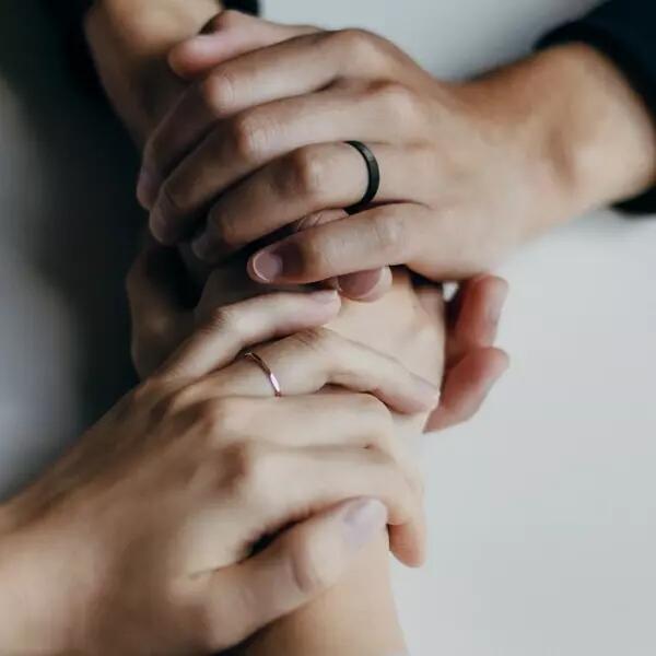 Two people holding hands